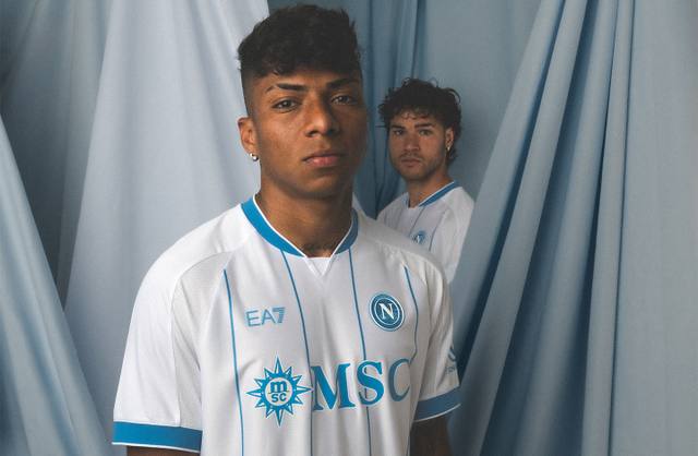 SSC Napoli players pose in the white and blue away shirt featuring vertical pinstripes and the MSC sponsor.