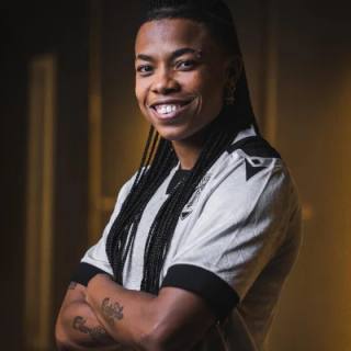A model posing in the Vitória SC 2025/26 home shirt.
