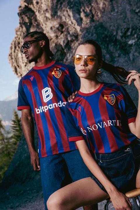 Models wearing the FC Basel 1893 home shirt in an outdoor campaign photoshoot.
