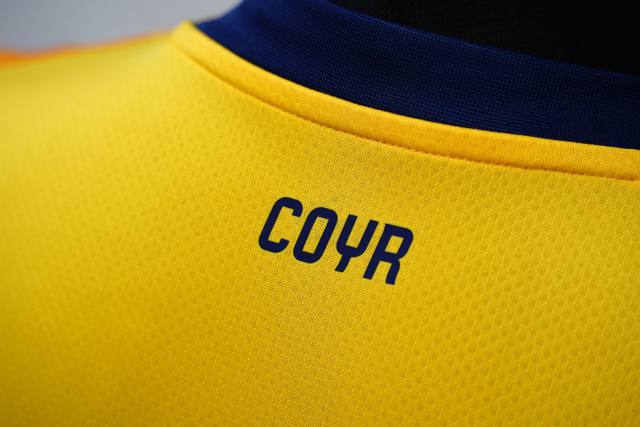 A close-up detail of the upper back of the Derby County 2024/25 third shirt, showing the printed initials COYR.