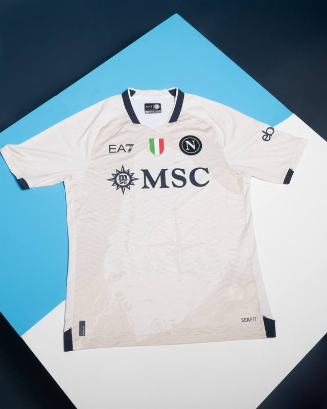 The SSC Napoli Everywhere Jersey by EA7, laid flat on a white and blue diagonal background.