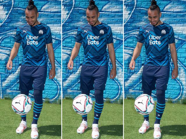 Dimitri Payet models the Olympique de Marseille 2021/22 away shirt in a repeating campaign image.