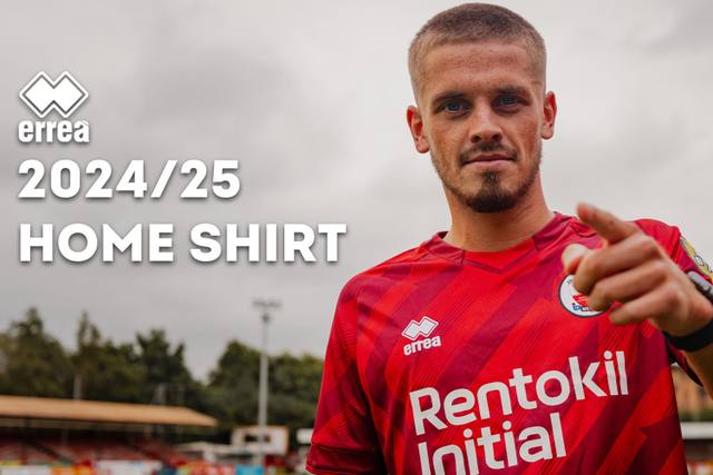 A player models the Erreà Crawley Town FC 2024/25 home shirt in a promotional graphic.