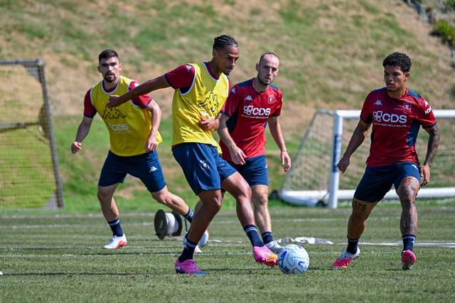 Genoa CFC players wearing red training shirts during a practice session