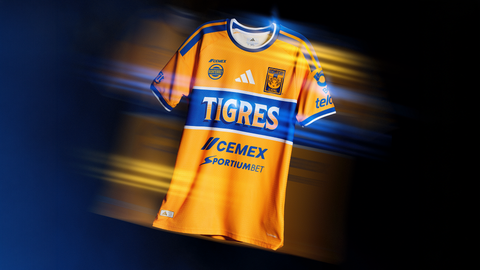 The Tigres UANL home shirt features a yellow body with a central blue horizontal band.