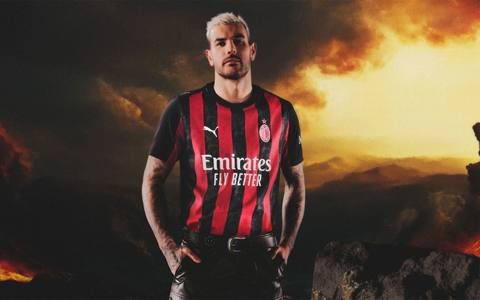 Theo Hernández models the AC Milan 2025/26 home shirt in a promotional campaign image.