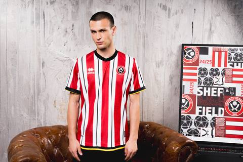 A model wears the Erreà Sheffield United 2024/25 home football shirt in a studio setting.