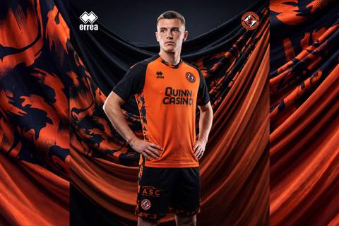 A player posing in the Dundee United 2026/27 home football shirt by Erreà.