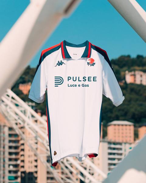 The white Genoa CFC 2024/25 away shirt suspended outdoors against a city background.