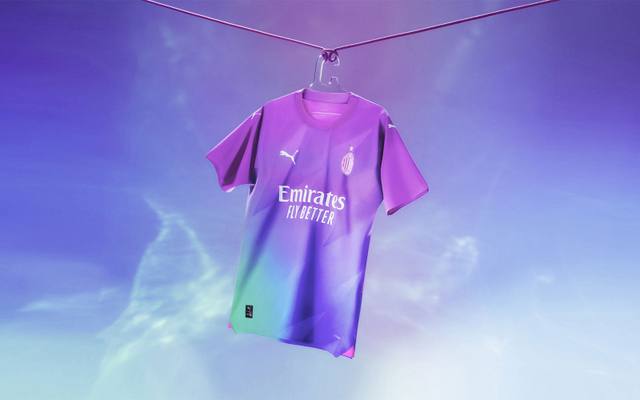An AC Milan 2023/24 third shirt featuring a vibrant purple, pink, and teal gradient design, hanging from a wire.