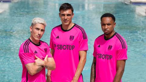 Harry Wilson, João Palhinha, and Kenny Tete wearing the Fulham 2023/24 pink away shirt.
