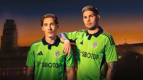Players presenting the Fulham FC 2025/26 away shirt during a campaign shoot at sunset.